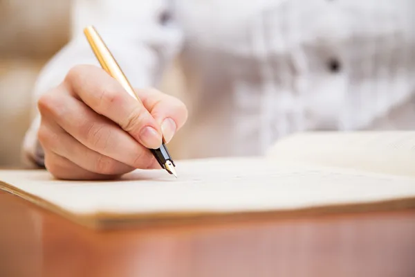 depositphotos_42806753-stock-photo-hand-with-pen-and-music